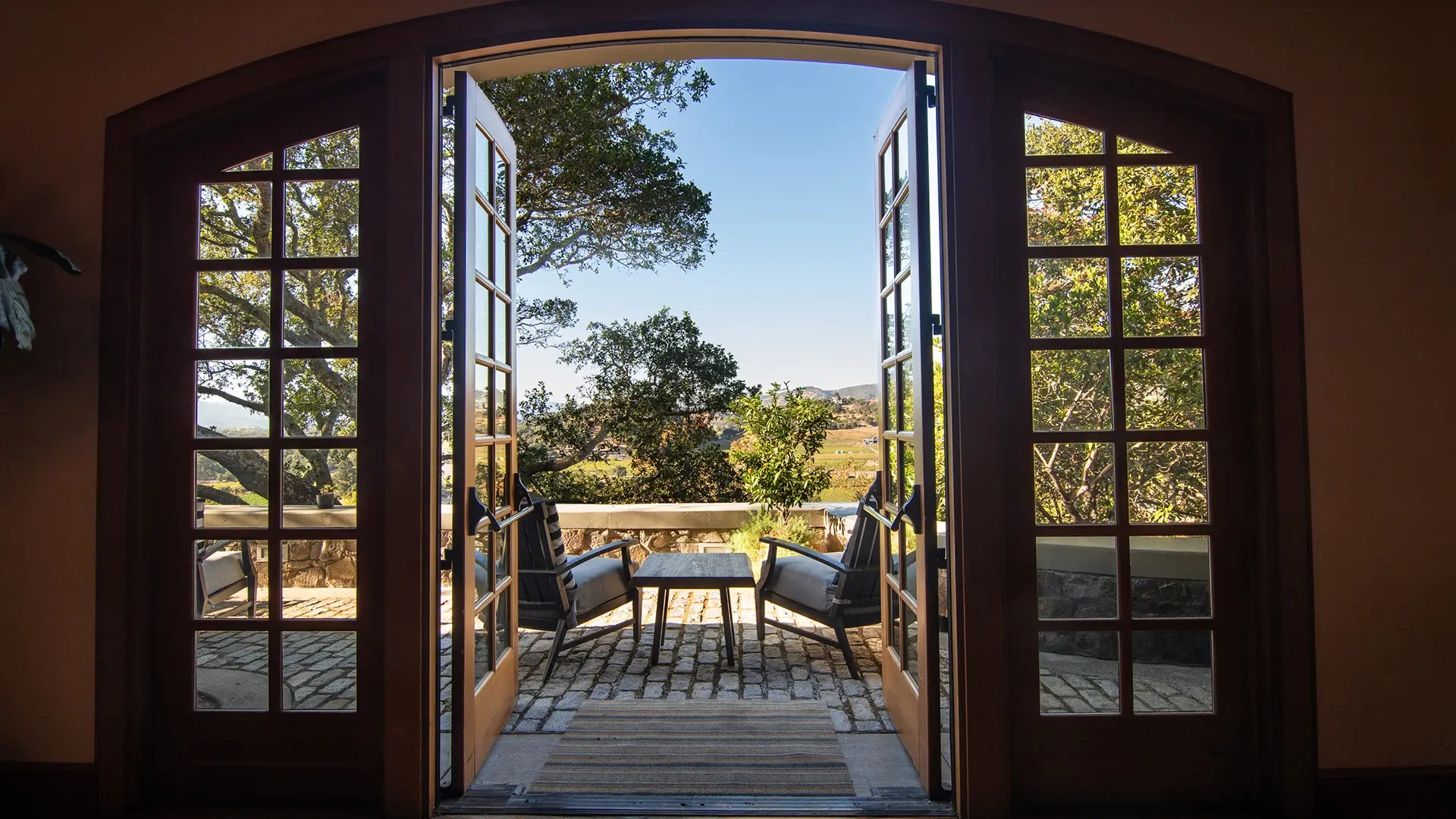 Open doors leading to a vineyard-view terrace at Silverado Vineyards